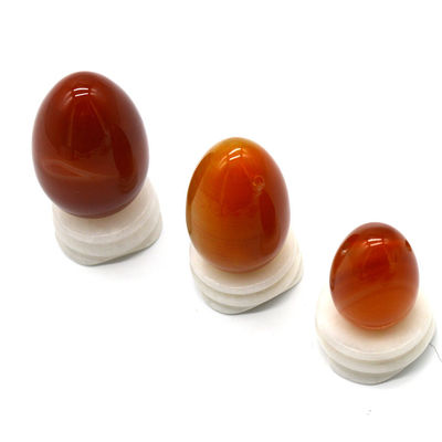 OEM ODM Aceptado huevos rojos de carnelia yoni huevos de piedra semipreciosa huevos perforados estilo de masaje
