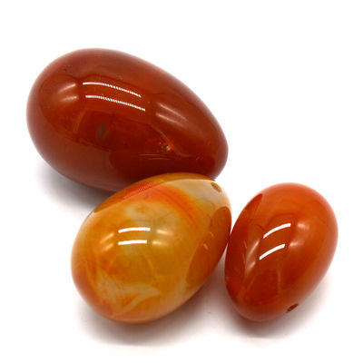 OEM ODM Aceptado huevos rojos de carnelia yoni huevos de piedra semipreciosa huevos perforados estilo de masaje