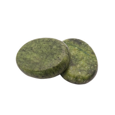Piedra caliente curativa de Jade Xiuyan para masajes profesionales y relajación en spa.
