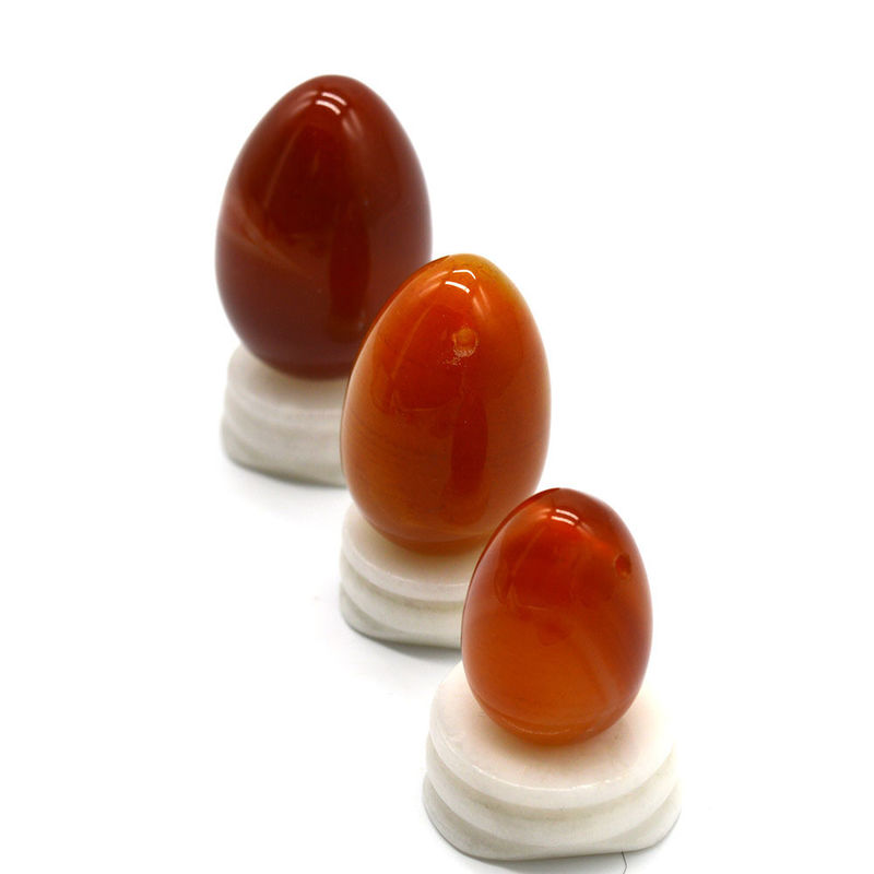 OEM ODM Aceptado huevos rojos de carnelia yoni huevos de piedra semipreciosa huevos perforados estilo de masaje